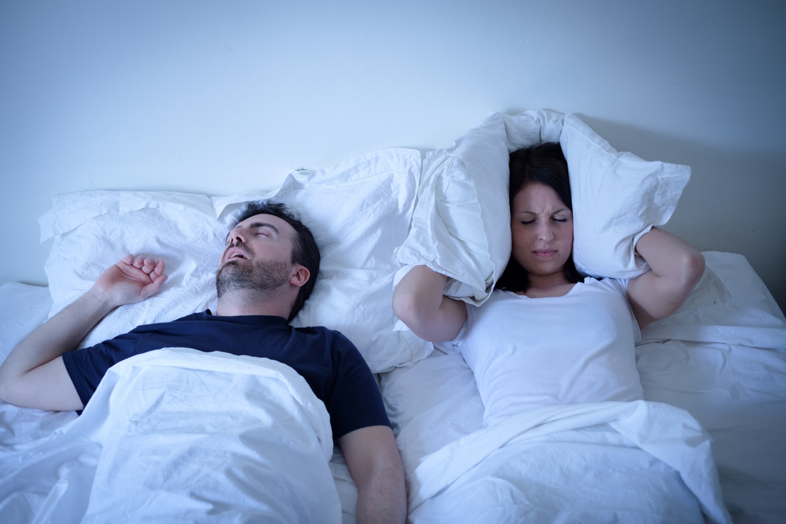 Woman unhappy as man snores in his sleep